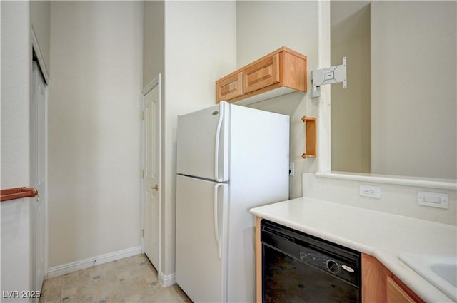 8768 Tom Noon Ave Unit 101, Las Vegas, NV 89178 - kitchen with freestanding refrigerator, dishwasher, and light countertops