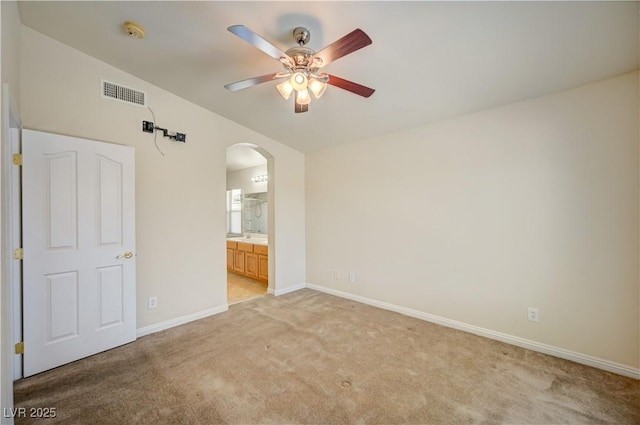 8768 Tom Noon Ave Unit 101, Las Vegas, NV 89178 - unfurnished bedroom with arched walkways, light colored carpet, vaulted ceiling, ensuite bath, and ceiling fan
