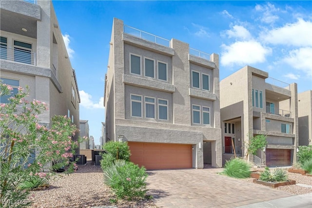 8072 Haywood Estate Ave, Las Vegas, NV 89113 - view of front of home featuring a garage, decorative driveway, and stucco siding