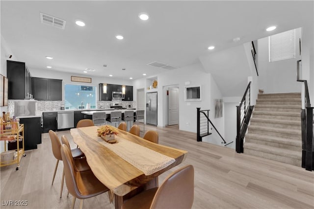 8072 Haywood Estate Ave, Las Vegas, NV 89113 - dining space featuring light wood finished floors, recessed lighting, and stairs