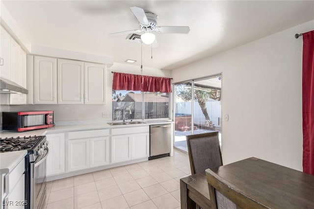2254 Florence Ave, Las Vegas, NV 89119 - kitchen with stainless steel appliances, light countertops, white cabinetry, ceiling fan, and light tile patterned floors
