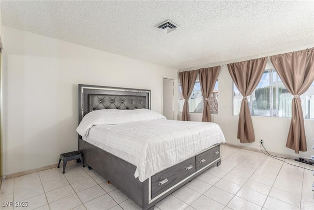 2254 Florence Ave, Las Vegas, NV 89119 - bedroom with light tile patterned flooring and a textured ceiling