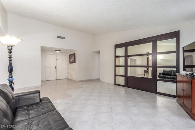 2254 Florence Ave, Las Vegas, NV 89119 - unfurnished living room with lofted ceiling and light tile patterned floors