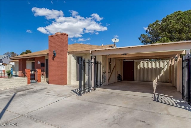 2254 Florence Ave, Las Vegas, NV 89119 - view of front of property featuring driveway, a chimney, stucco siding, and a carport