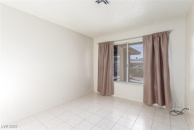 2254 Florence Ave, Las Vegas, NV 89119 - spare room featuring a textured ceiling and light tile patterned floors