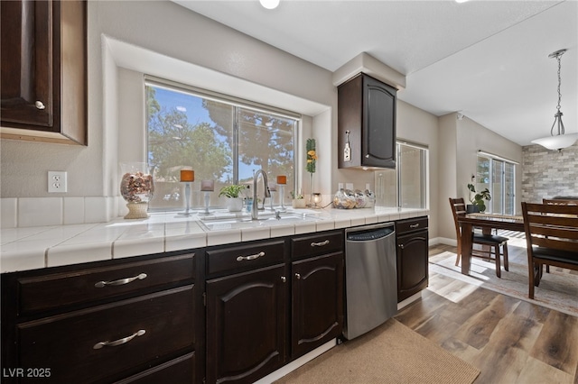 5452 Desert Spring Rd, Las Vegas, NV 89149 - kitchen featuring dishwasher, healthy amount of natural light, wood finished floors, and tile counters