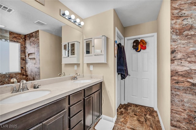 10312 Glimmering Star Dr, Las Vegas, NV 89178 - bathroom featuring baseboards and double vanity