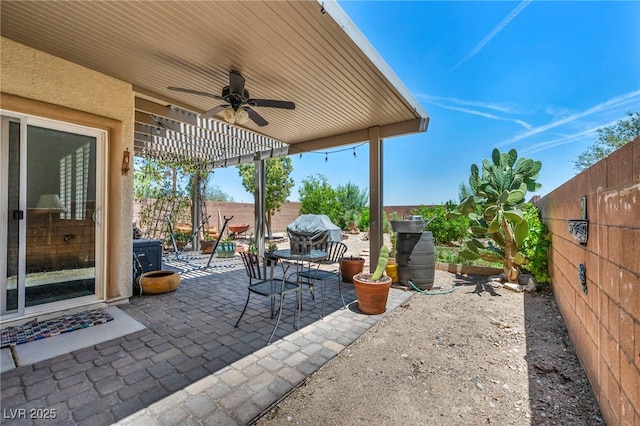 10312 Glimmering Star Dr, Las Vegas, NV 89178 - fenced backyard with ceiling fan, a patio area, and a grill