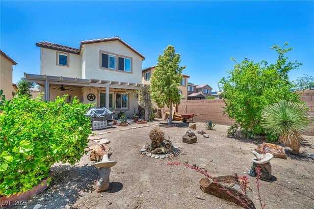 10312 Glimmering Star Dr, Las Vegas, NV 89178 - rear view of house with ceiling fan, a fenced backyard, a pergola, stucco siding, and a tile roof