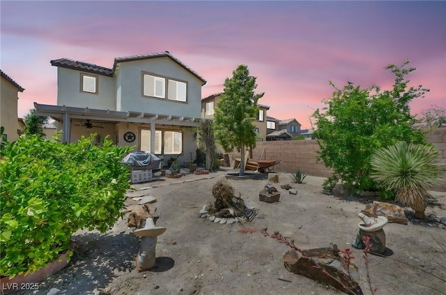 10312 Glimmering Star Dr, Las Vegas, NV 89178 - back of house at dusk featuring a ceiling fan, a pergola, a tiled roof, a patio area, and stucco siding