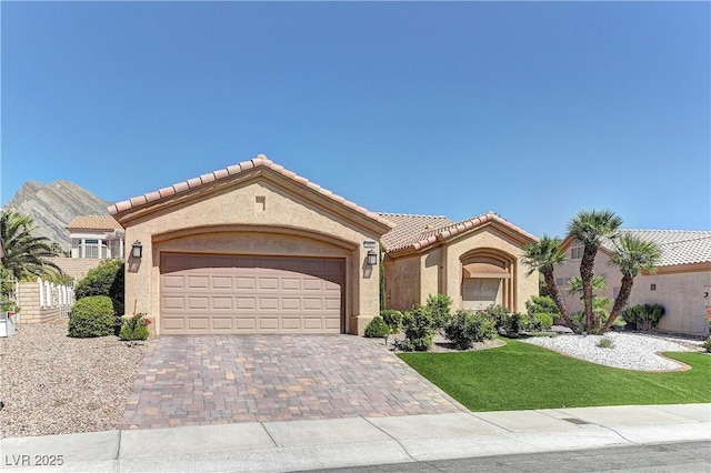 2605 Orchid Valley Dr, Las Vegas, NV 89134 - mediterranean / spanish-style home featuring a garage, decorative driveway, stucco siding, and a tile roof