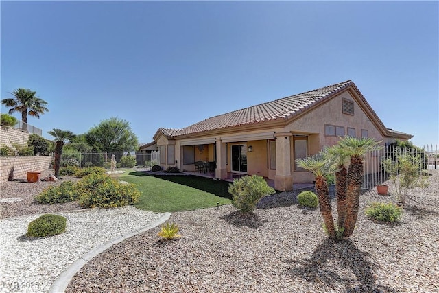 2605 Orchid Valley Dr, Las Vegas, NV 89134 - rear view of house featuring stucco siding, a tile roof, and a patio area