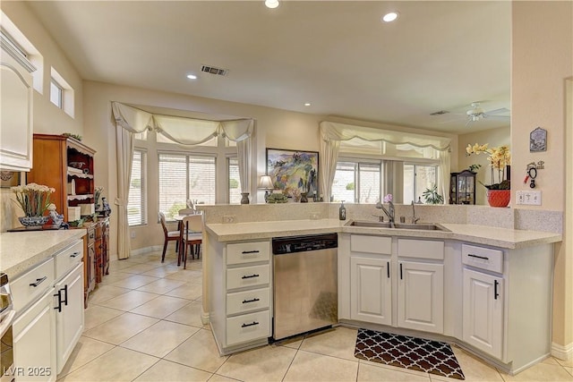 2605 Orchid Valley Dr, Las Vegas, NV 89134 - kitchen featuring stainless steel dishwasher, light countertops, light tile patterned floors, and recessed lighting