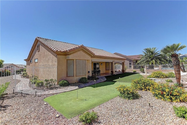 2605 Orchid Valley Dr, Las Vegas, NV 89134 - back of house with a putting area, a tiled roof, stucco siding, and a patio