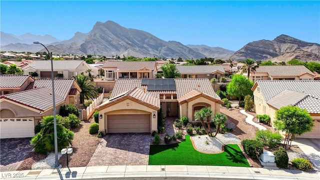 2605 Orchid Valley Dr, Las Vegas, NV 89134 - mediterranean / spanish house with a residential view, decorative driveway, stucco siding, and solar panels