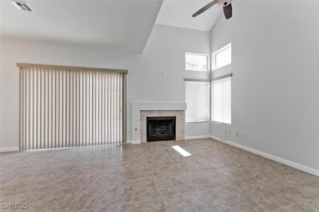 1663 Cloister Ave, Henderson, NV 89014 - unfurnished living room with a ceiling fan, high vaulted ceiling, plenty of natural light, a tiled fireplace, and tile patterned floors