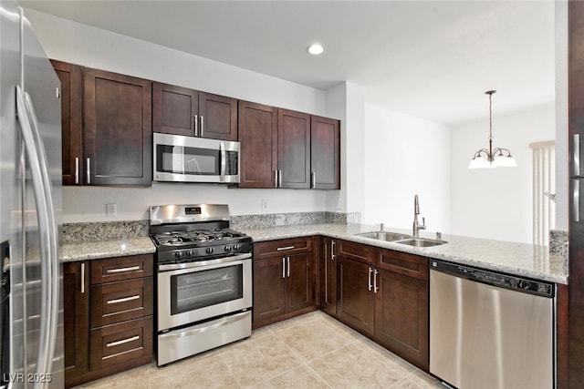1663 Cloister Ave, Henderson, NV 89014 - kitchen with stainless steel appliances, dark brown cabinets, light tile patterned floors, a chandelier, and light stone counters