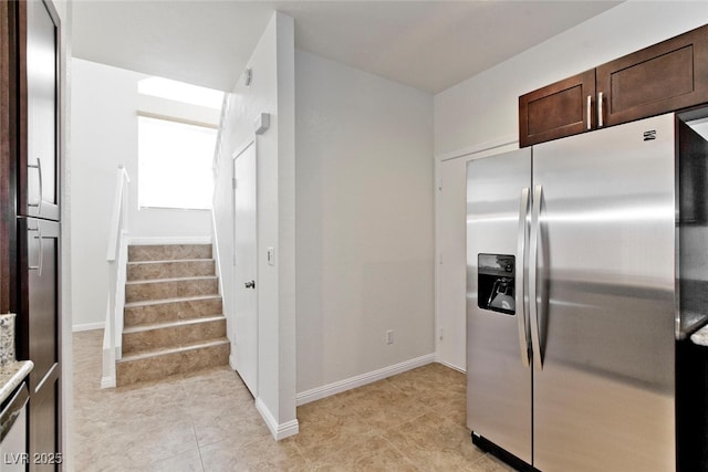 1663 Cloister Ave, Henderson, NV 89014 - kitchen with stainless steel fridge with ice dispenser, dark brown cabinets, and light tile patterned flooring
