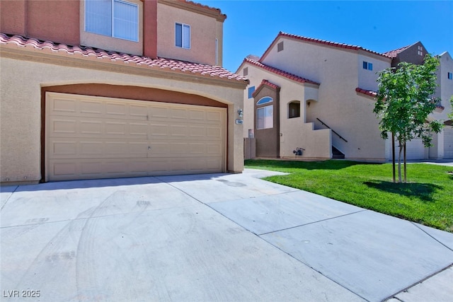 1663 Cloister Ave, Henderson, NV 89014 - mediterranean / spanish-style home featuring an attached garage, stucco siding, a tile roof, a front lawn, and concrete driveway