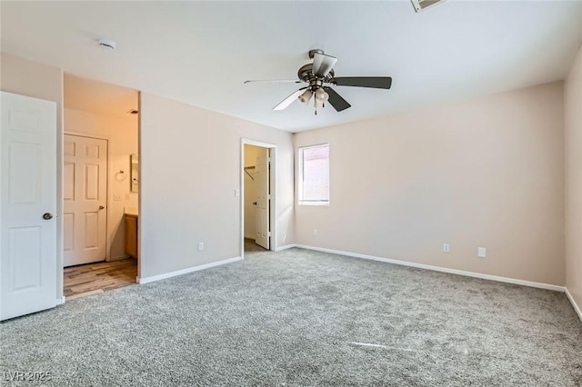 7547 Rolling River Dr, Las Vegas, NV 89131 - unfurnished bedroom featuring carpet flooring, a walk in closet, ensuite bath, and ceiling fan