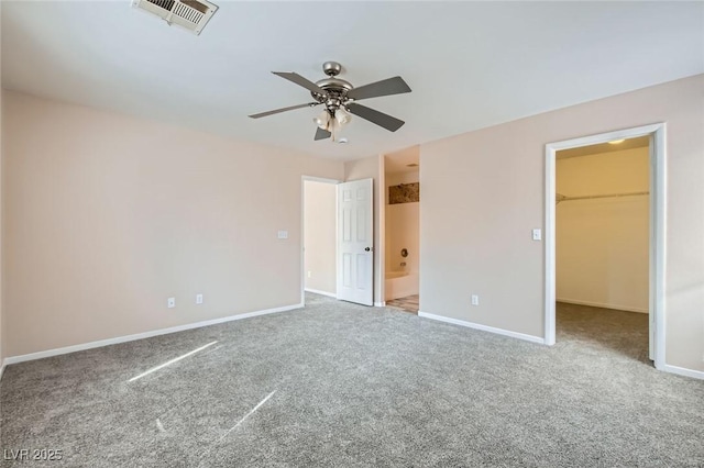 7547 Rolling River Dr, Las Vegas, NV 89131 - unfurnished bedroom with a spacious closet, carpet flooring, connected bathroom, and ceiling fan