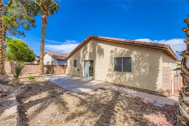 7547 Rolling River Dr, Las Vegas, NV 89131 - rear view of property featuring stucco siding, a fenced backyard, a patio area, and a tiled roof