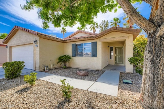 7547 Rolling River Dr, Las Vegas, NV 89131 - ranch-style house featuring an attached garage, stucco siding, and a tiled roof