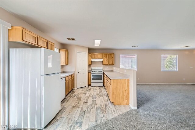 7547 Rolling River Dr, Las Vegas, NV 89131 - kitchen featuring white appliances, under cabinet range hood, light countertops, and a peninsula