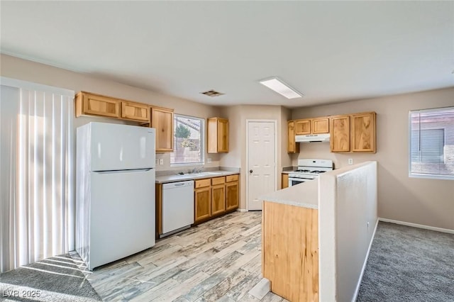 7547 Rolling River Dr, Las Vegas, NV 89131 - kitchen featuring white appliances, under cabinet range hood, light countertops, and light brown cabinetry