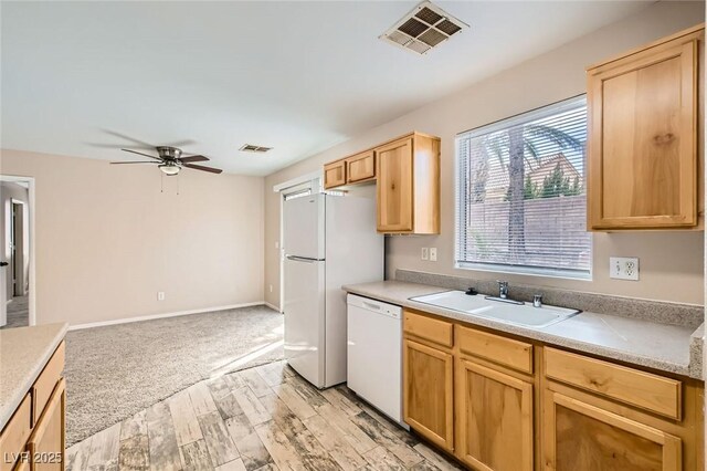 7547 Rolling River Dr, Las Vegas, NV 89131 - kitchen featuring white appliances, light wood-type flooring, a ceiling fan, light brown cabinetry, and light countertops