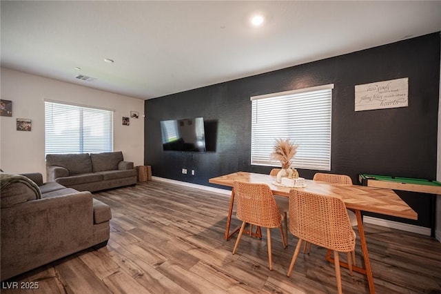 9256 Alden Pointe Ct, Las Vegas, NV 89143 - dining space with wood finished floors and an accent wall