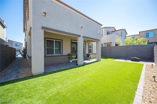 9256 Alden Pointe Ct, Las Vegas, NV 89143 - rear view of house featuring a patio, a fenced backyard, an outdoor fire pit, and stucco siding