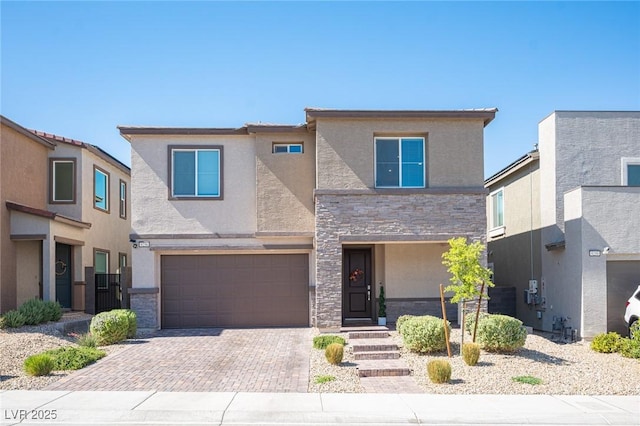 9256 Alden Pointe Ct, Las Vegas, NV 89143 - view of front of house featuring stone siding, stucco siding, a garage, and decorative driveway