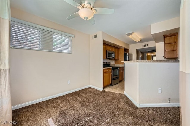 4400 S Jones Blvd Unit 2007, Las Vegas, NV 89103 - kitchen featuring appliances with stainless steel finishes, light colored carpet, brown cabinetry, ceiling fan, and open shelves