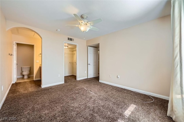 4400 S Jones Blvd Unit 2007, Las Vegas, NV 89103 - unfurnished bedroom with arched walkways, carpet floors, a walk in closet, a ceiling fan, and a closet