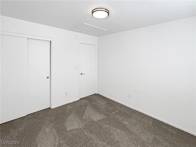 6696 Merced Lake Dr, Las Vegas, NV 89156 - unfurnished bedroom with dark carpet, attic access, and a closet