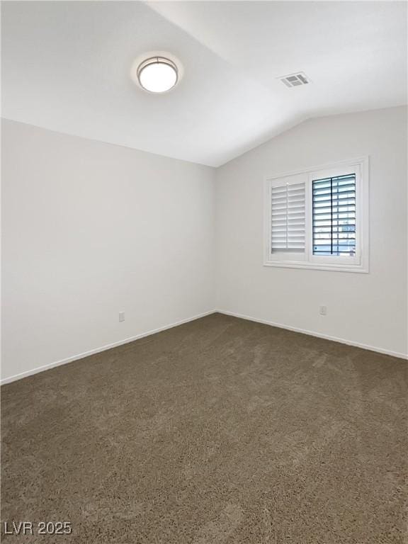 6696 Merced Lake Dr, Las Vegas, NV 89156 - empty room featuring vaulted ceiling and dark carpet
