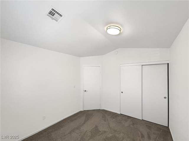 6696 Merced Lake Dr, Las Vegas, NV 89156 - unfurnished bedroom featuring carpet flooring, vaulted ceiling, and a closet
