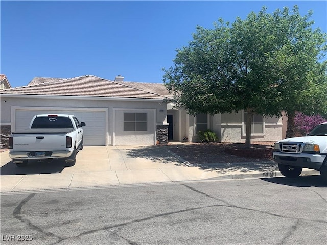 1008 Beaver Crest Ter, Henderson, NV 89015 - view of front facade with a garage, stucco siding, driveway, and a tiled roof