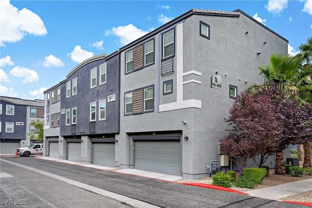 9050 W Tropicana Ave Unit 1027, Las Vegas, NV 89147 - view of property featuring a garage