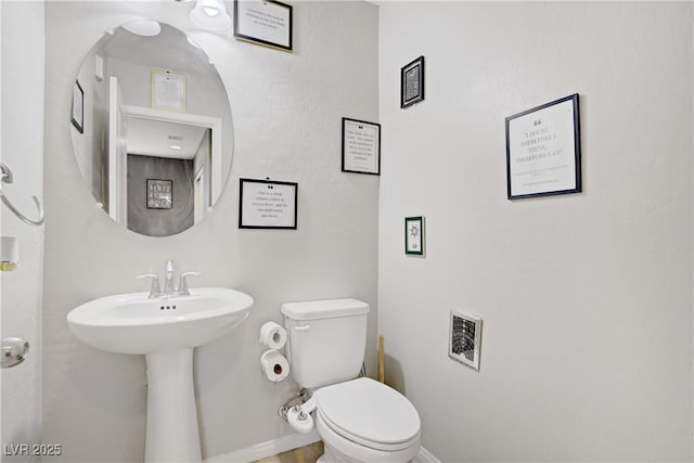 9050 W Tropicana Ave Unit 1027, Las Vegas, NV 89147 - bathroom with toilet and baseboards