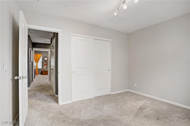 9050 W Tropicana Ave Unit 1027, Las Vegas, NV 89147 - unfurnished bedroom featuring light colored carpet and a closet