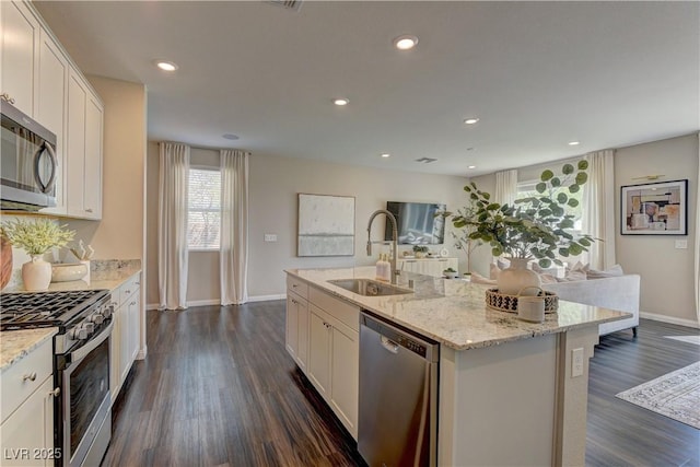 7705 Alder Forest St, Las Vegas, NV 89113 - kitchen with stainless steel appliances, plenty of natural light, dark wood-style flooring, white cabinetry, and recessed lighting