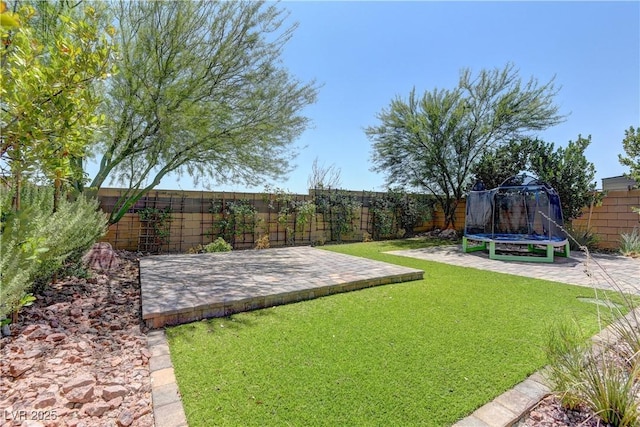 7705 Alder Forest St, Las Vegas, NV 89113 - fenced backyard with a trampoline and a patio area