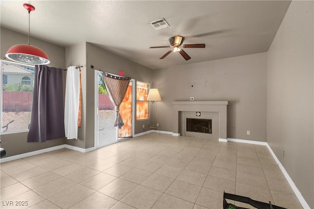2500 Cortina Ave, Henderson, NV 89074 - unfurnished living room featuring plenty of natural light, a ceiling fan, tile patterned flooring, and a fireplace