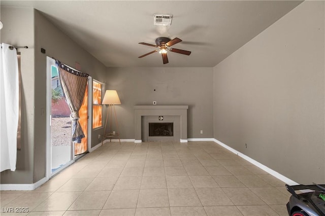 2500 Cortina Ave, Henderson, NV 89074 - unfurnished living room with ceiling fan, a fireplace, and light tile patterned floors