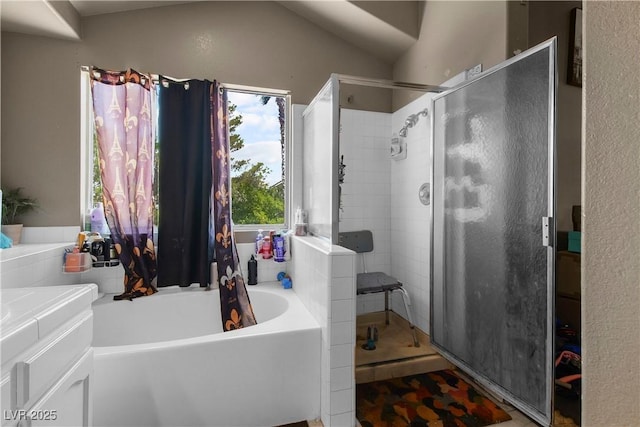 2500 Cortina Ave, Henderson, NV 89074 - bathroom featuring a stall shower, a garden tub, vanity, and vaulted ceiling