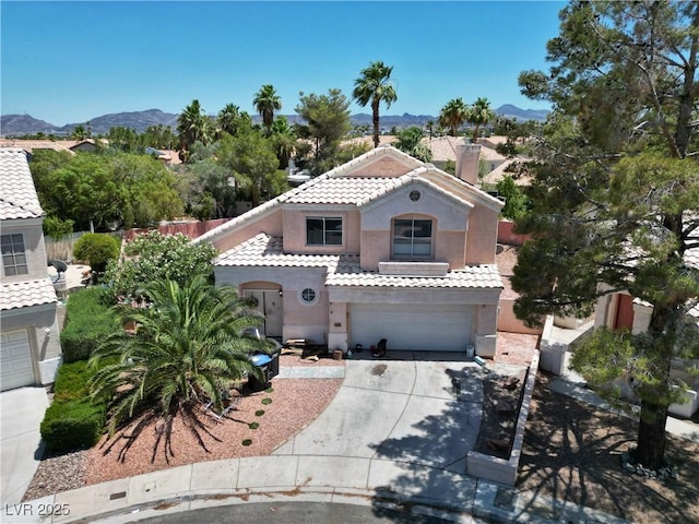 2500 Cortina Ave, Henderson, NV 89074 - mediterranean / spanish-style home with a garage, stucco siding, concrete driveway, a mountain view, and a tiled roof