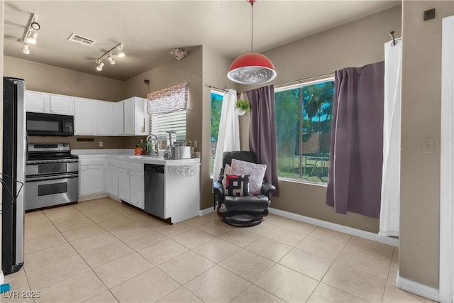 2500 Cortina Ave, Henderson, NV 89074 - kitchen with stainless steel appliances, white cabinets, light countertops, and light tile patterned floors