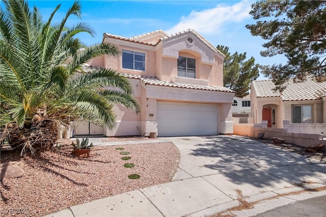 2500 Cortina Ave, Henderson, NV 89074 - mediterranean / spanish home featuring driveway, stucco siding, a tiled roof, and an attached garage